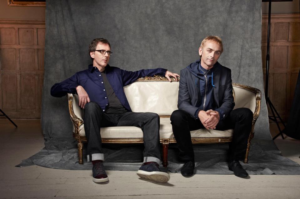Underworld band members sitting on a sofa - Electric Gardens Australia 2019 - Lineupping