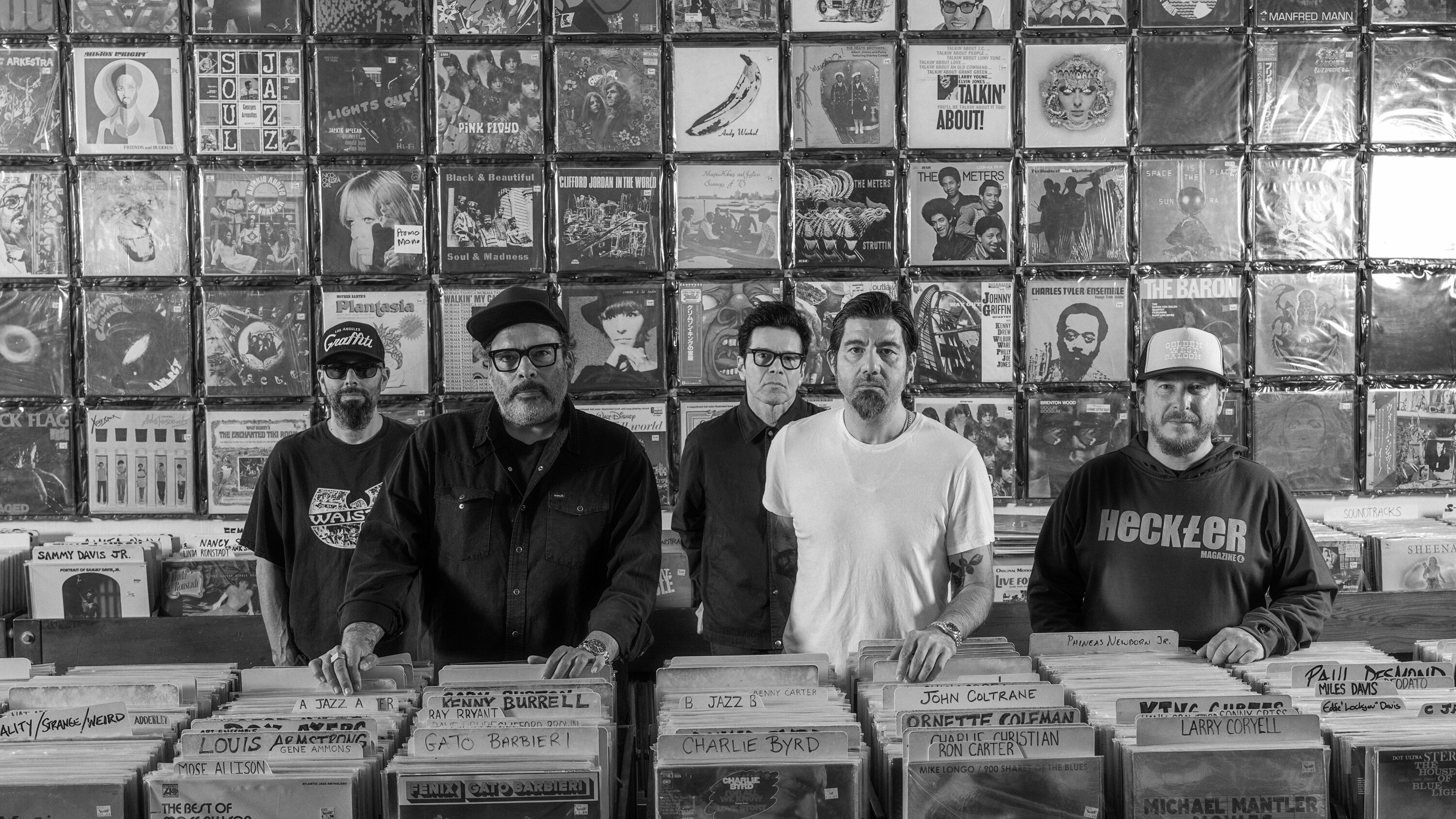 Portrait of Deftones band members standing up in a record store - credits Devin Oktar Yalkin New York Times - Lollapalooza Chile 2026 - Lineupping.com