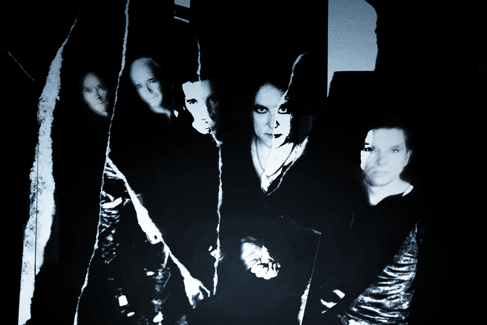 Portrait of The Cure band members standing up with black background - credits Rock Werchter - The Cure tour dates - Lineupping.com